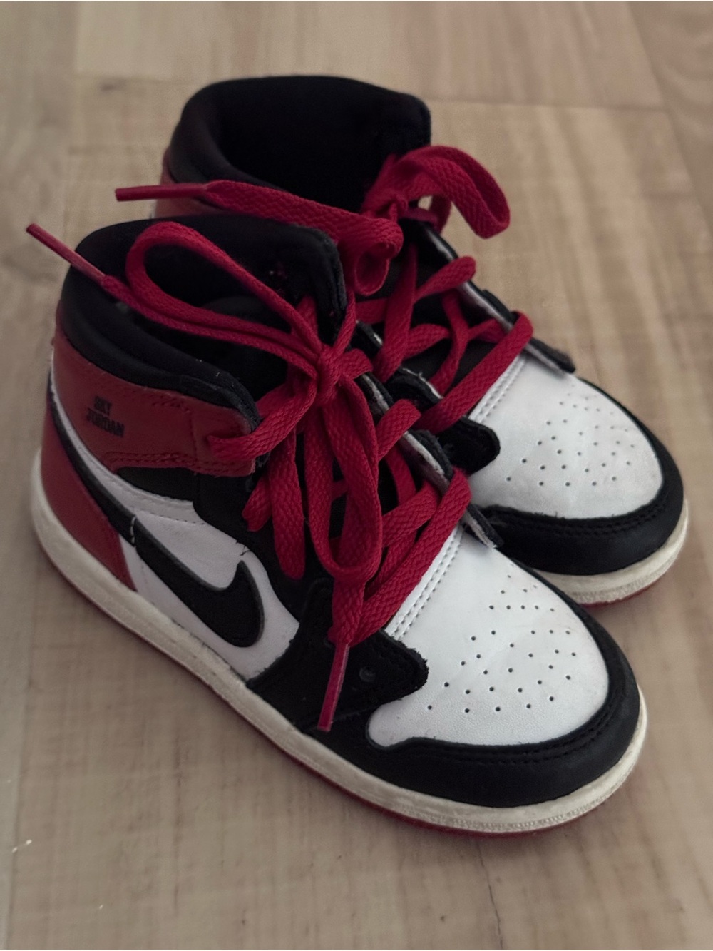 Air Jordan 1 Retro High OG TD 'Black Toe Reimagined' toddler sneakers.
